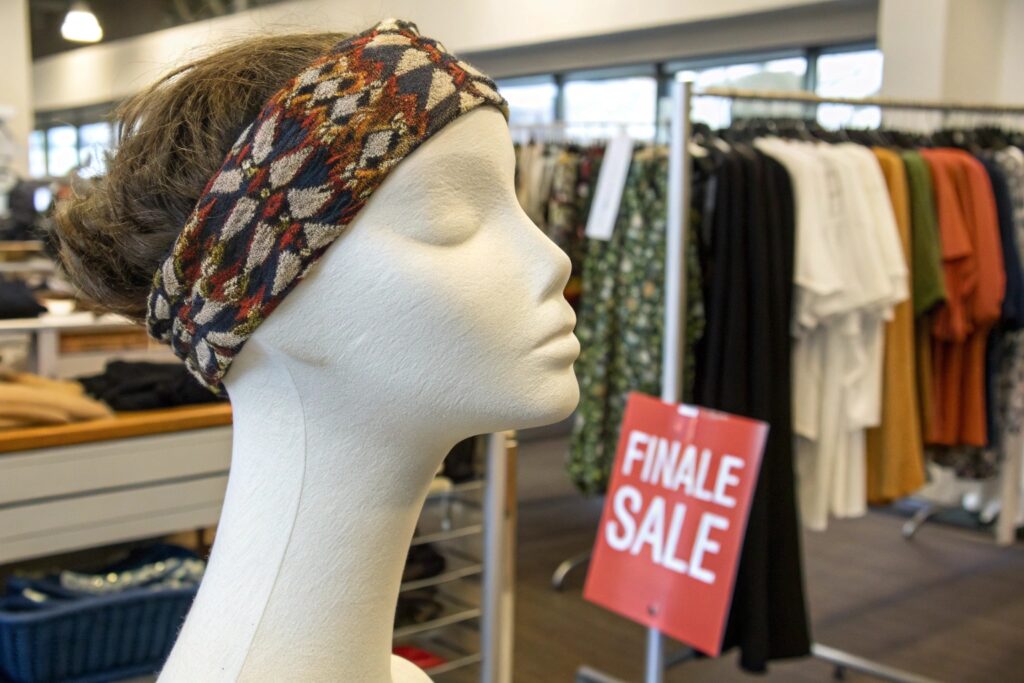 A mannequin wearing a headband in a clothing store