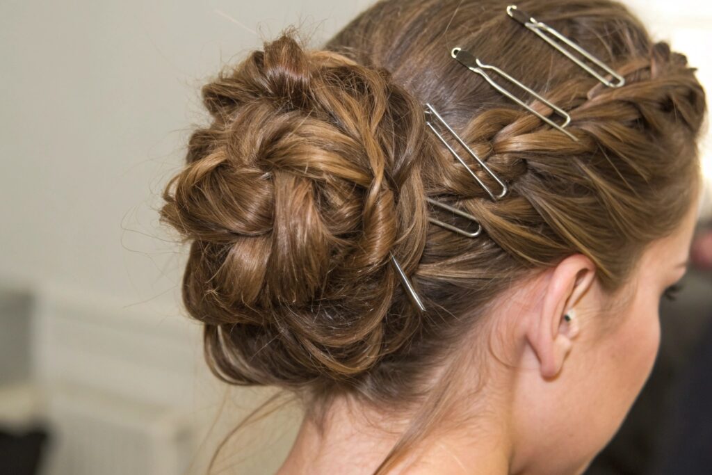 A woman with a braided bun hairstyle