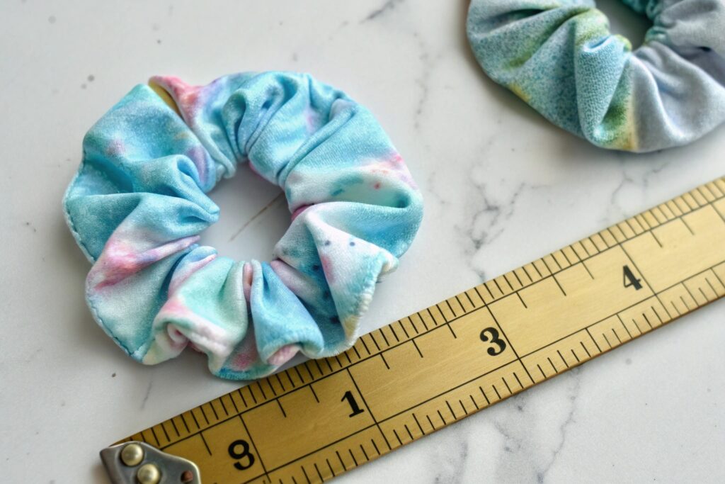 Two tie-dye scrunchies and a ruler