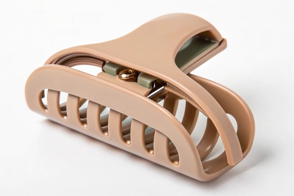 A beige claw hair clip