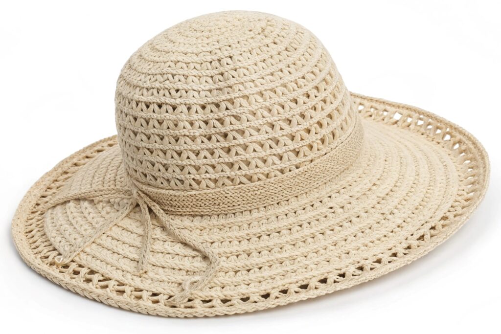 A beige crochet cloche hat on a white surface