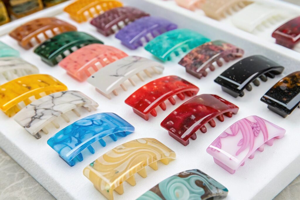 A tray of many colorful plastic hair claw clips arranged in rows
